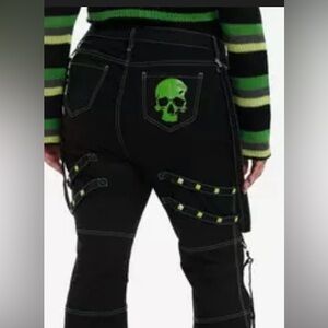 Black and green skull strap flare pants from Hot Topic